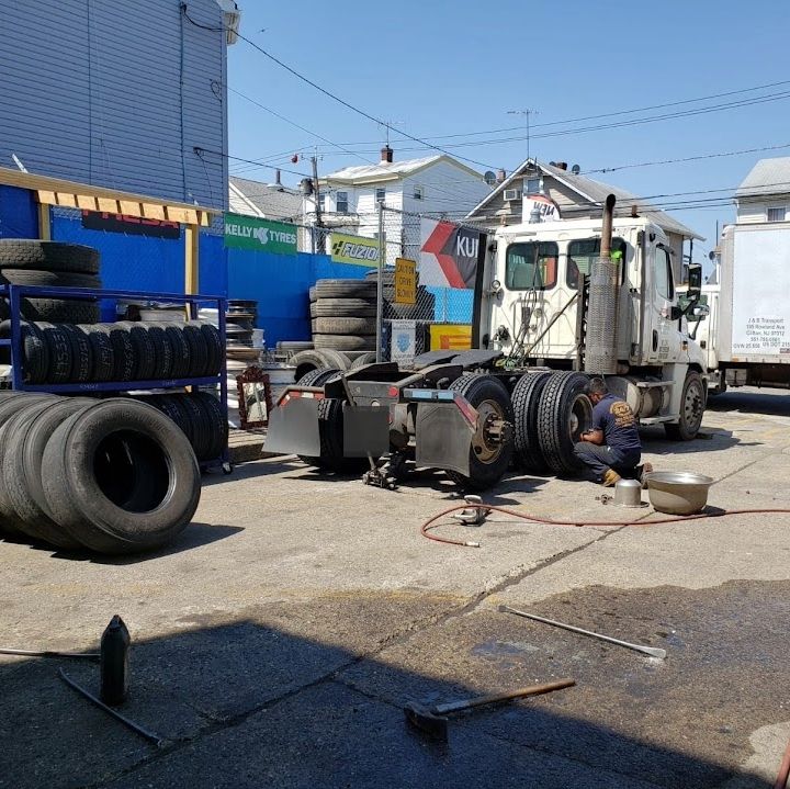 Semi-truck tire being serviced in the yard at Edgar Tire Service
