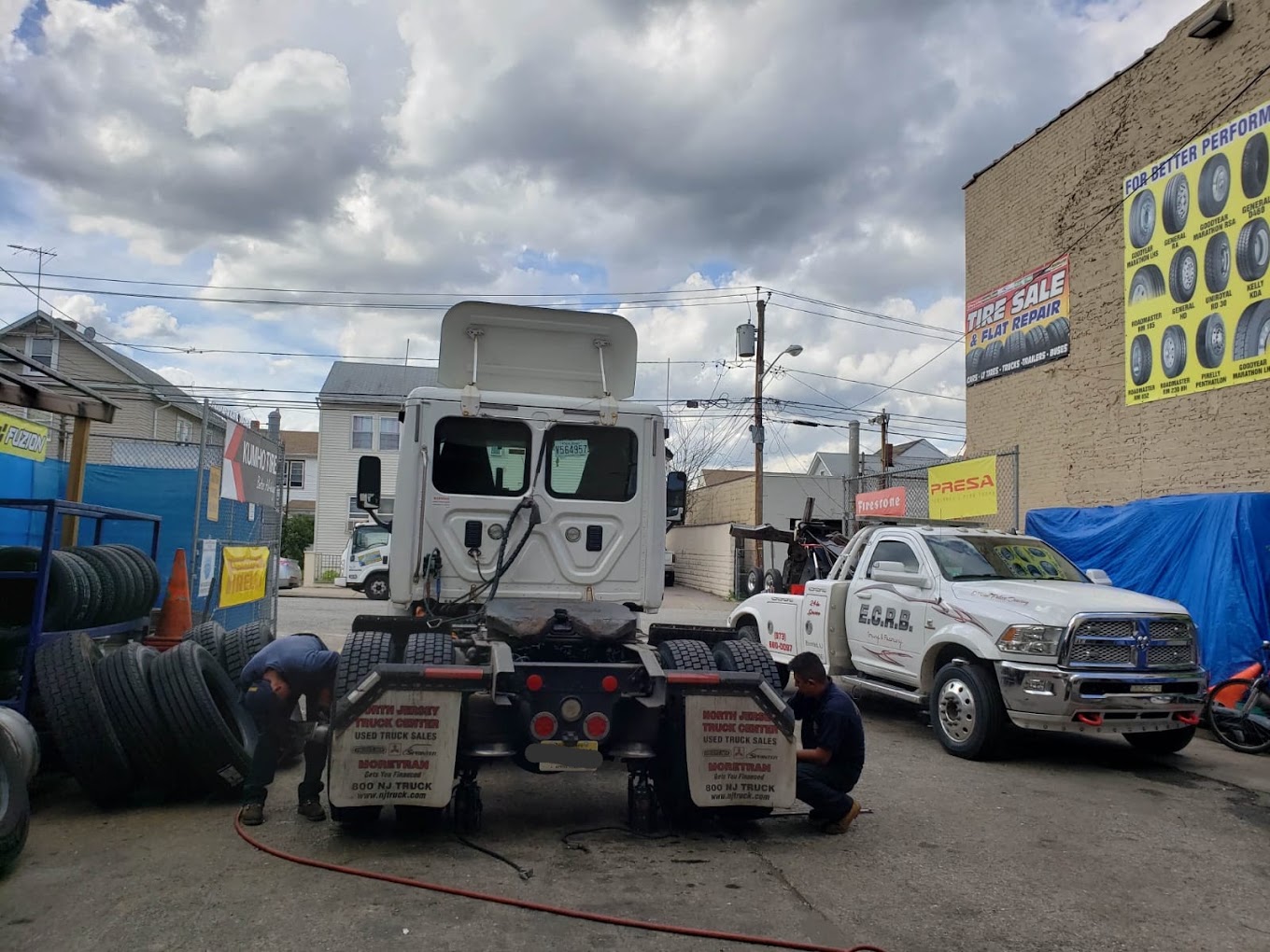 Technician replacing a commercial truck tire at Edgar Tire Service in Paterson, New Jersey